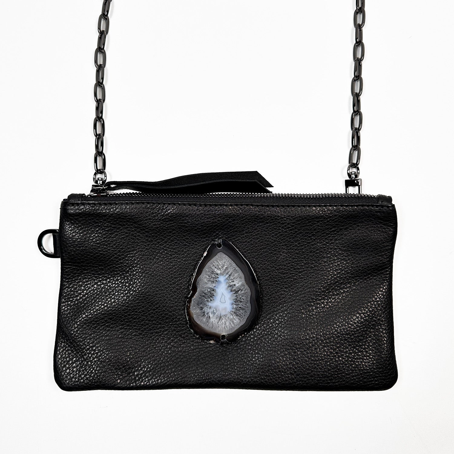 The Victoria Bag in black Italian leather by Evoke Women, featuring a striking agate decoration. This versatile accessory can be worn as a crossbody, belt bag, or wristlet, showcasing a sleek design that transitions effortlessly from day to night.