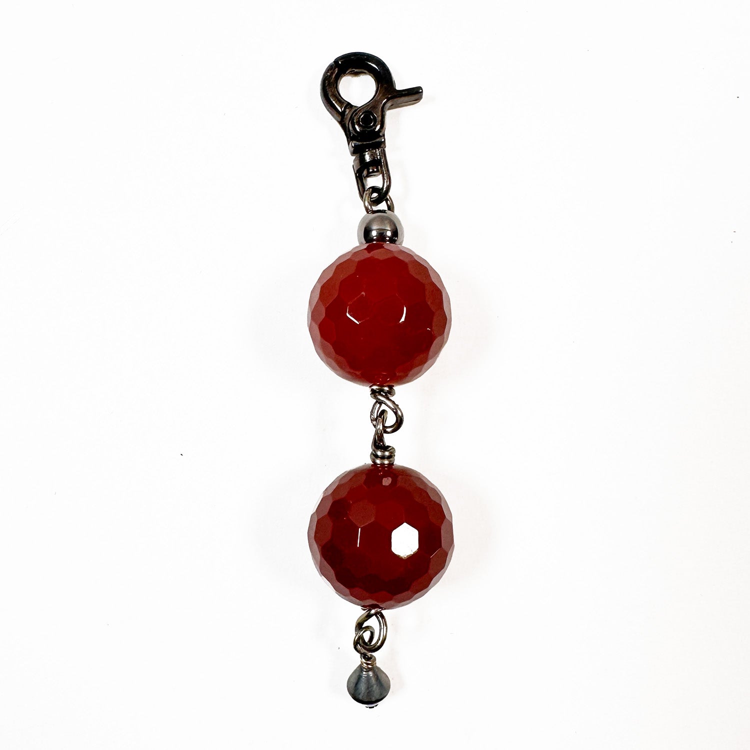 Introducing the Wine Agate Charm by evokewomen, a keychain adorned with two large red agate beads and a small gray clip-on charm, ideal for enthusiasts of gunmetal accessories.