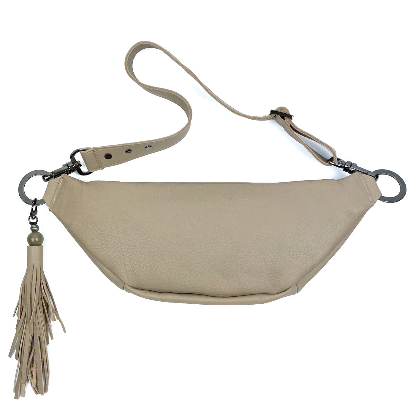 The STELLA - SAND leather sling bag by evokewomen features an adjustable strap and a chic tassel keychain.