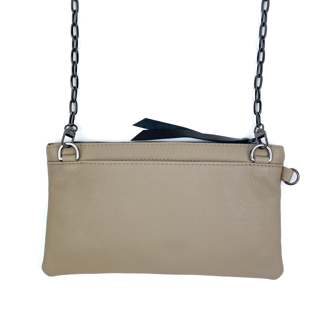 A VICTORIA - SAND crossbody bag by evokewomen, featuring a beige leather exterior, a black metal chain strap, and a top zipper closure.